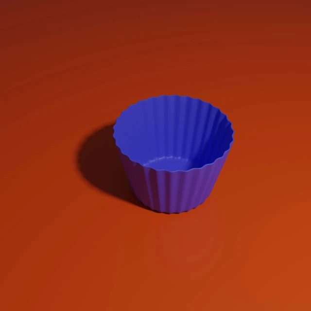 a blue paper muffin pan sitting on top of a red surface