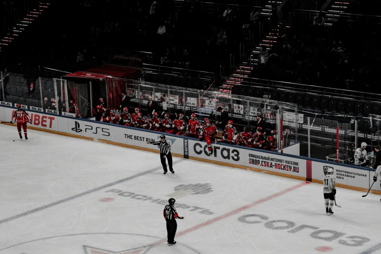 an ice rink is empty as several players stand on it