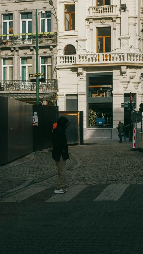 a person is walking across an open street