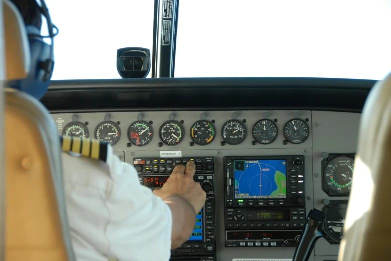 a pilot inside of a plane with control panel