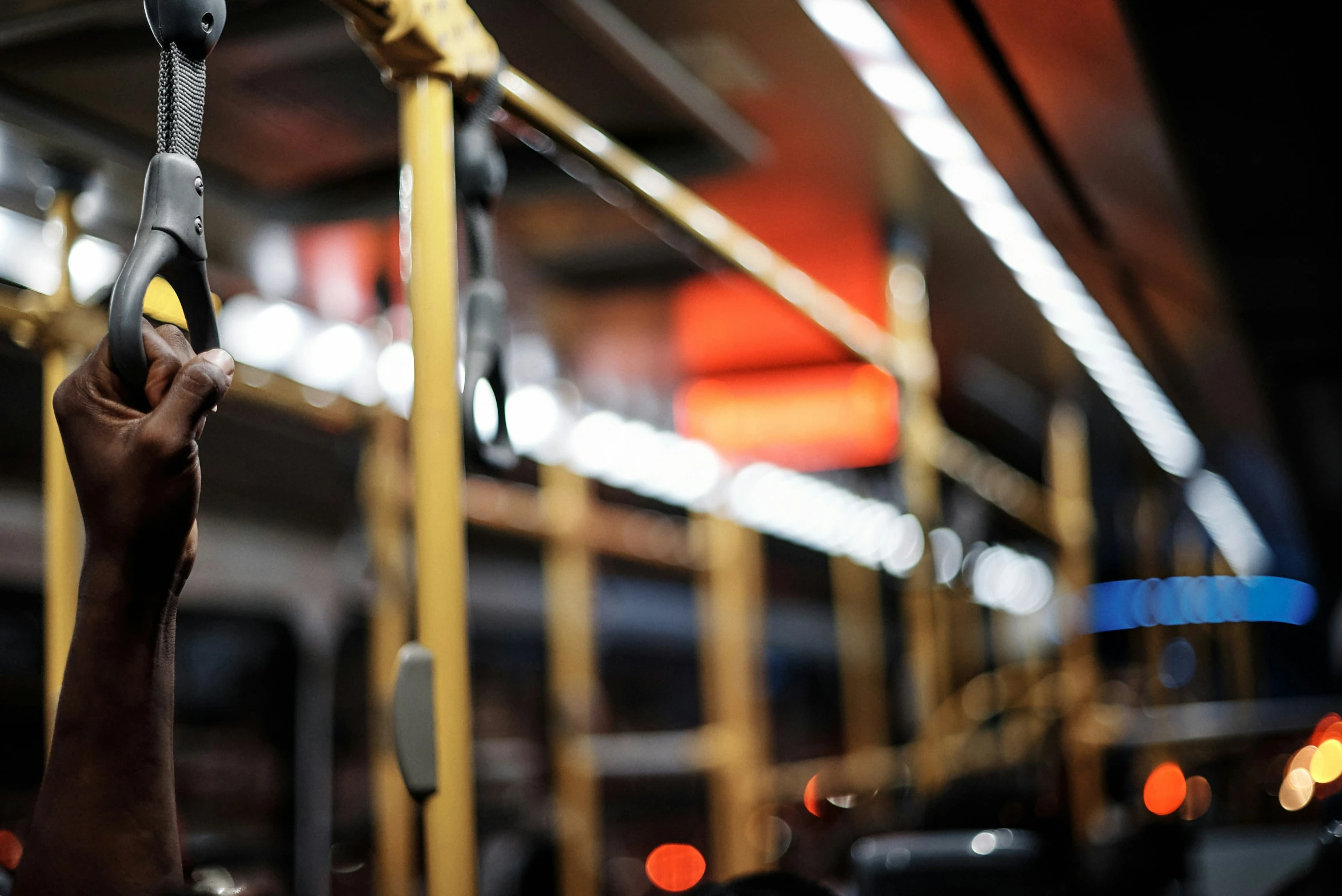 people on the bus are holding onto the handles