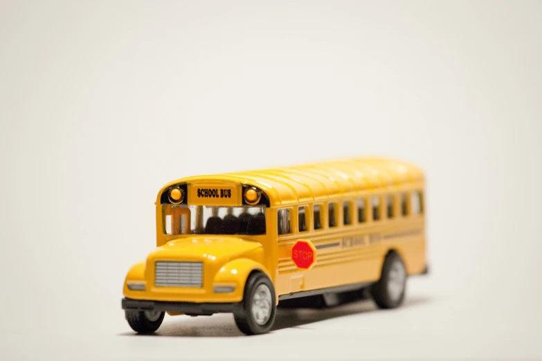 a toy yellow school bus with one end open