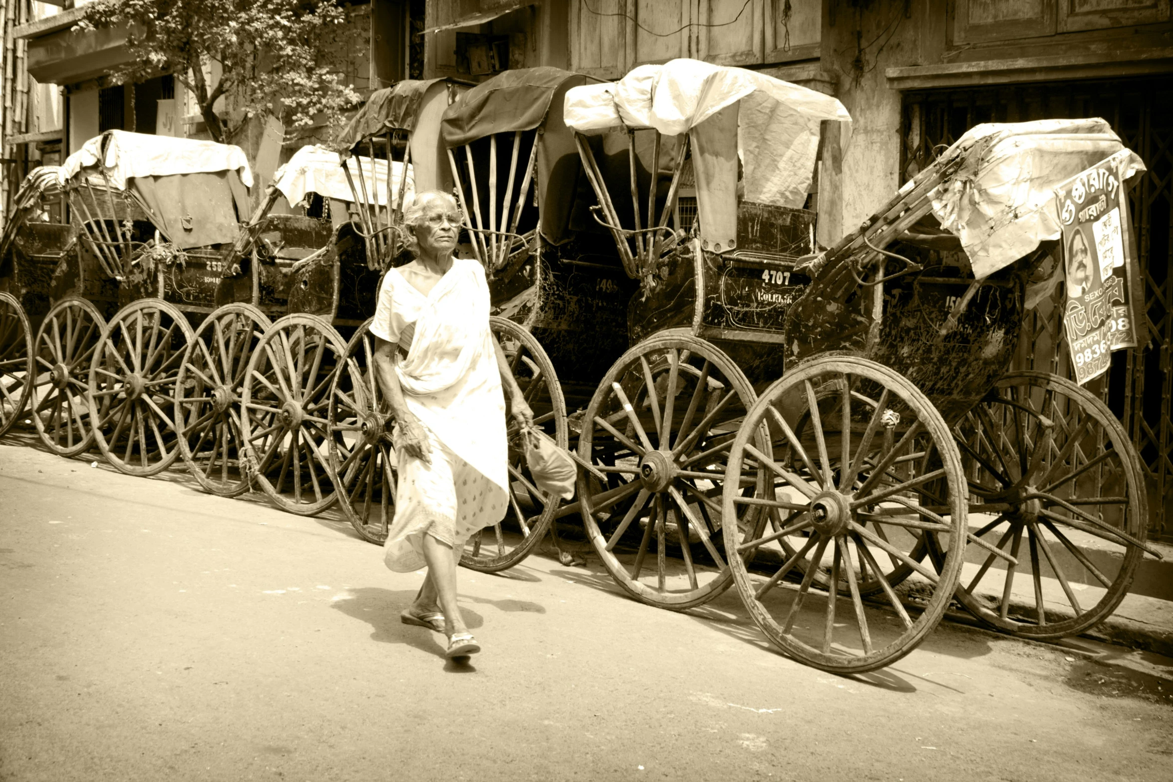 an old pograph shows several antique wooden rickshaws