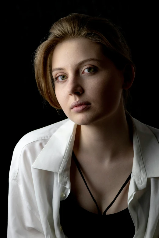 a woman with brown hair and white shirt