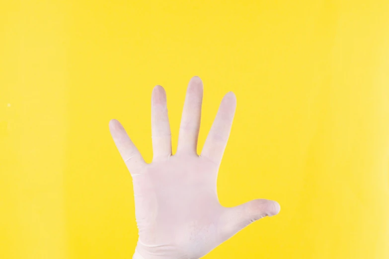 a person's hand with both hands extended and a yellow background