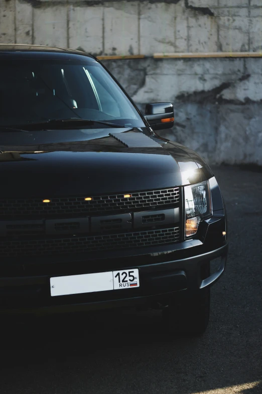 a black pickup truck with a number plate on it