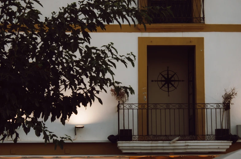 an old fashioned porch with iron railing and light