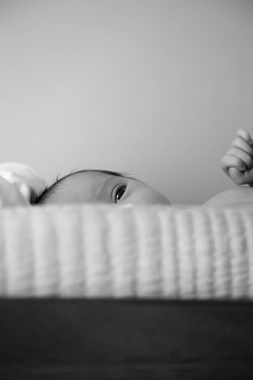 an image of a baby in the crib with a man pointing at it