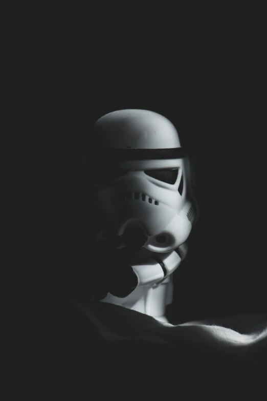 a stormtrooper is sitting in the shadows