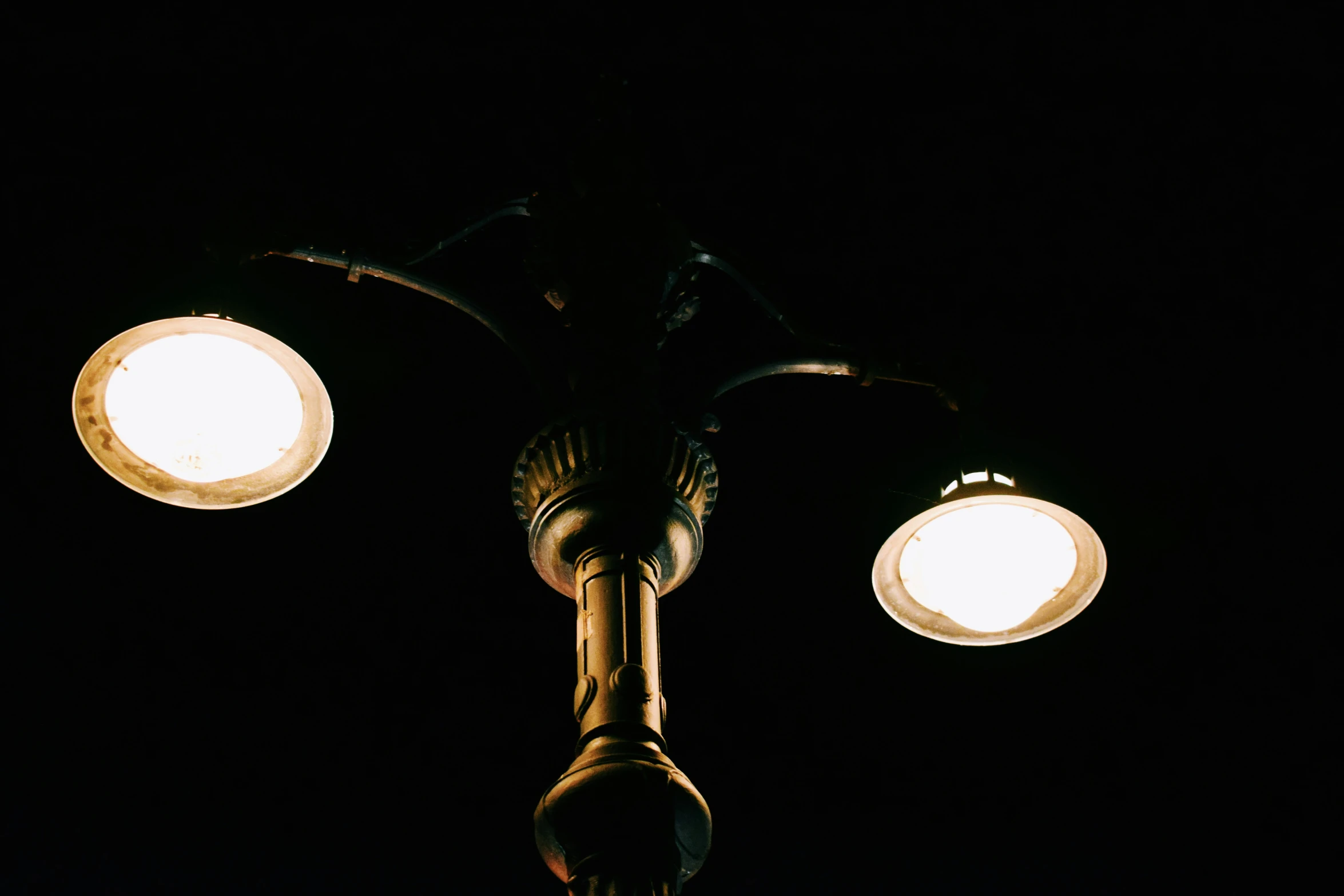 three light bulbs lit up against a dark background