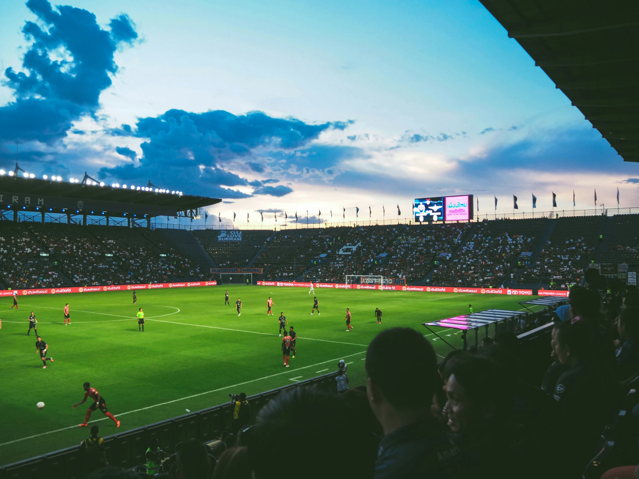 people watching an international soccer match in the evening