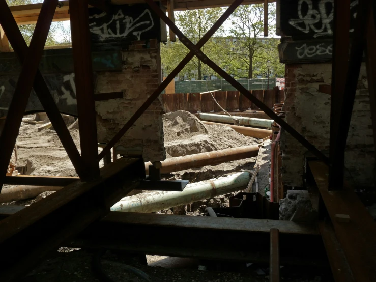 a large pipe sitting on top of a pile of dirt