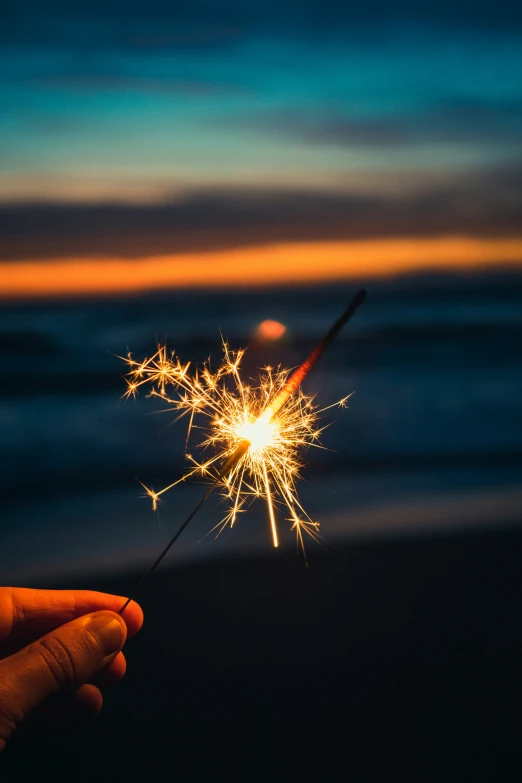 someone holding a sparkler that has just broken