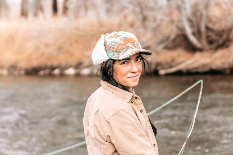 a young woman smiles while sitting in a boat in water