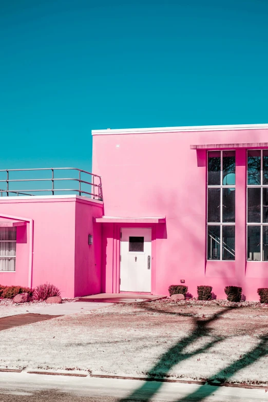 there are two windows that are next to the pink building