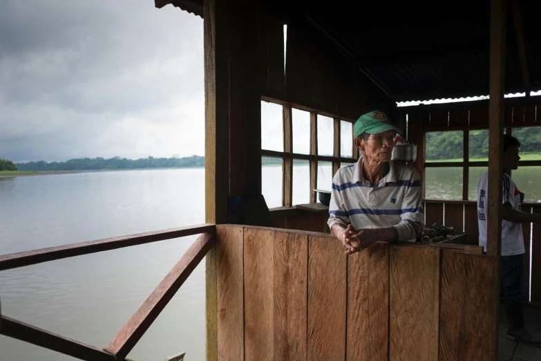 a person sitting next to a wall on a boat