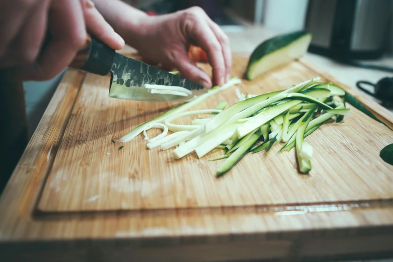 the man is  vegetables in his kitchen