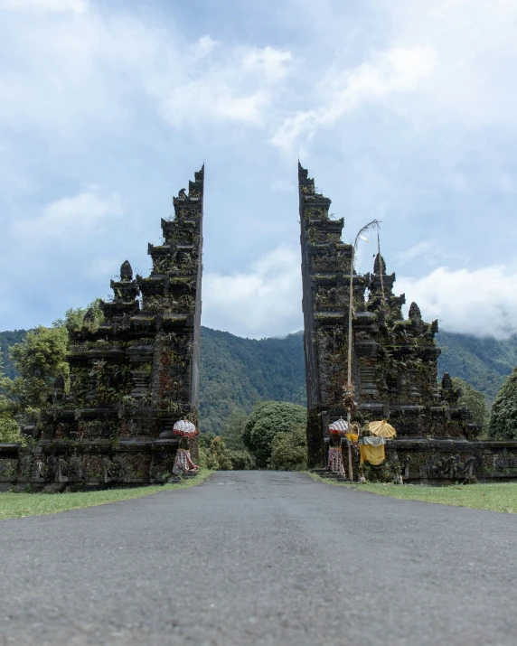 a scenic view of an entrance to a lush green hillside