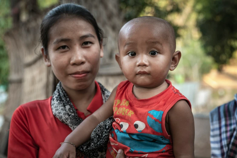 a woman and child in a red top with  on