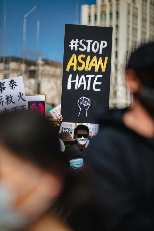 the protest is outside on the street with people holding signs