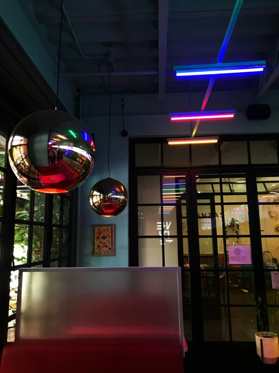 neon lights hang from ceiling above a building