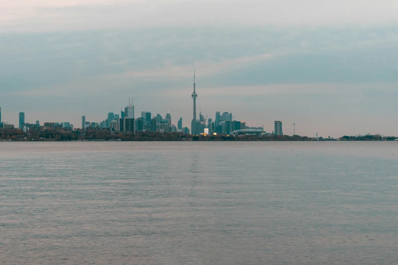 cityscape in the distance with river and water behind it