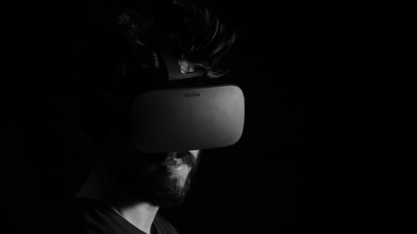 a man wearing a vr headset in the dark
