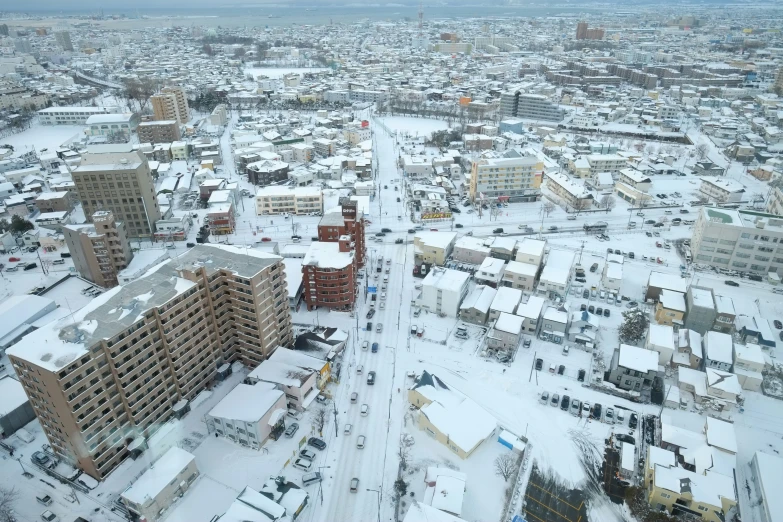 the aerial view shows an area where buildings are surrounded by snow