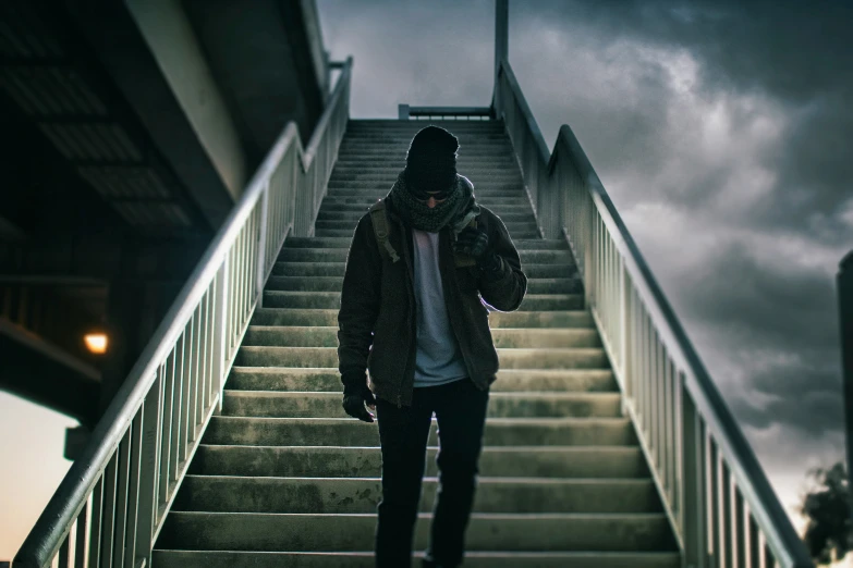 a man walking up some steps in the rain