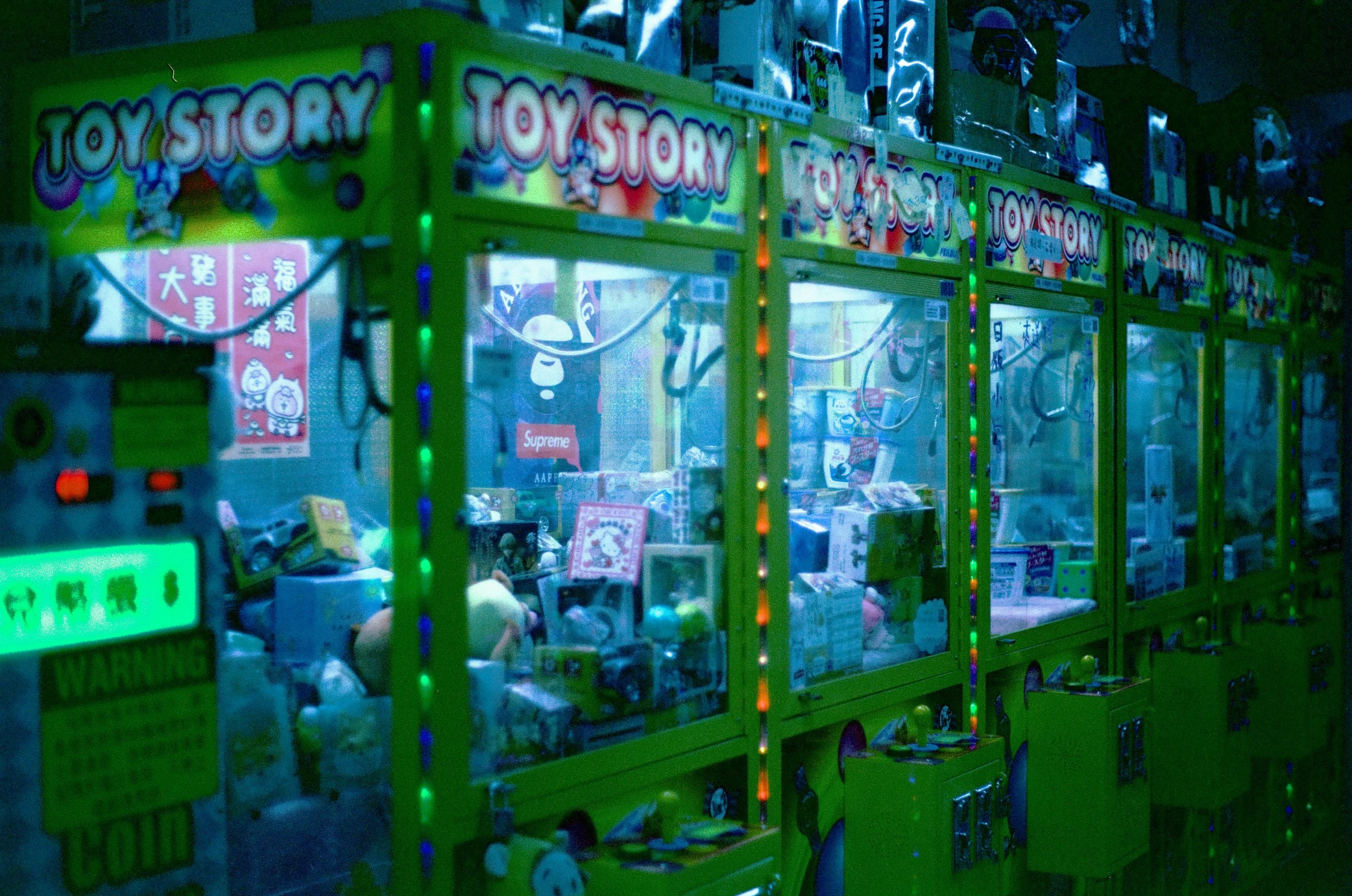 a green toy store with a neon sign inside of it