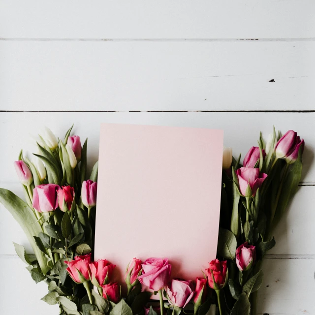 a po album cover sitting on top of pink flowers