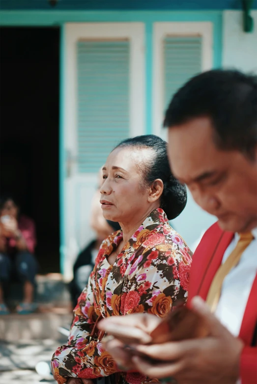 a man in a dress shirt and woman wearing a floral print top