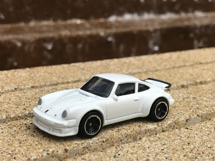 a toy white car sitting on a table