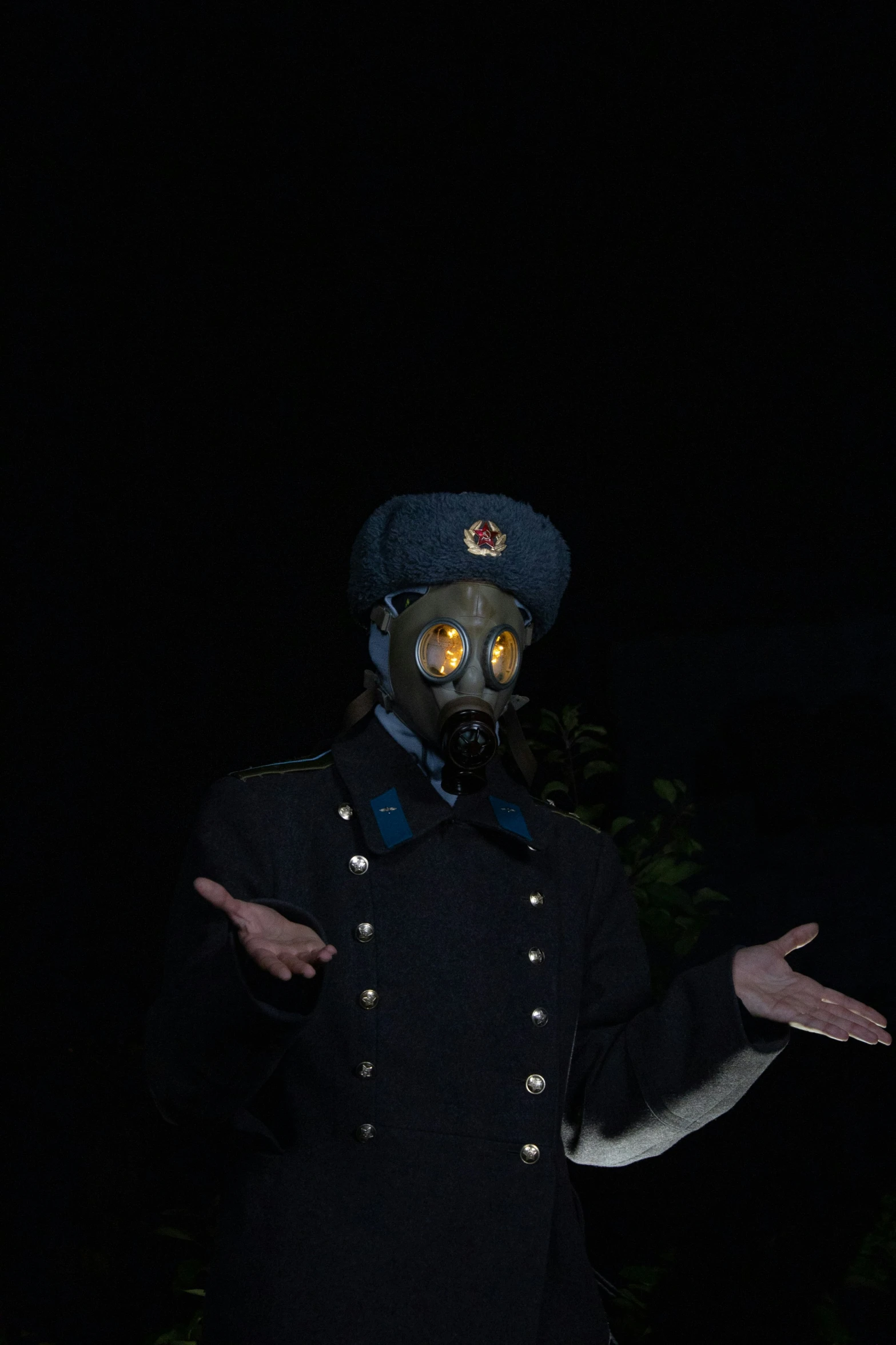 a man dressed in uniform wearing a gas mask