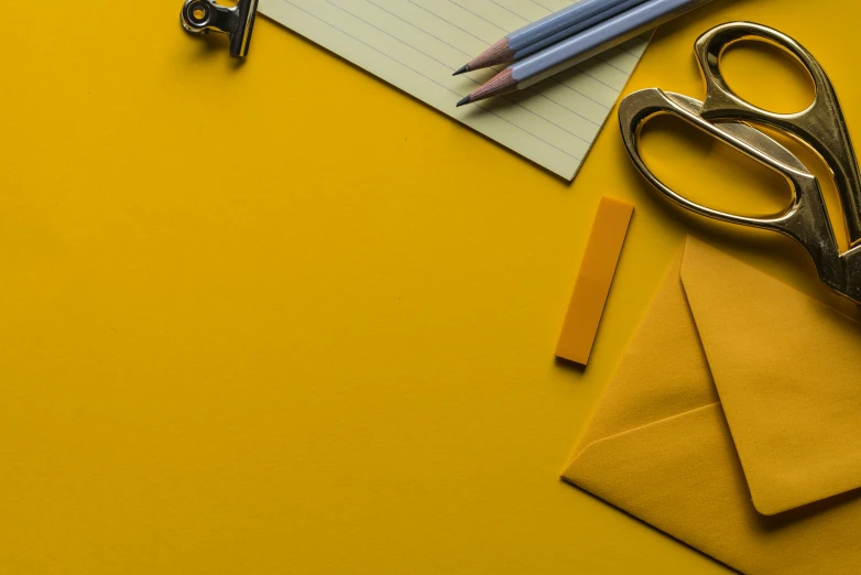 a pair of scissors and a pen on top of a table