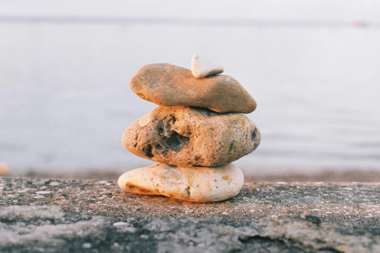 a close up of three rocks stacked next to each other