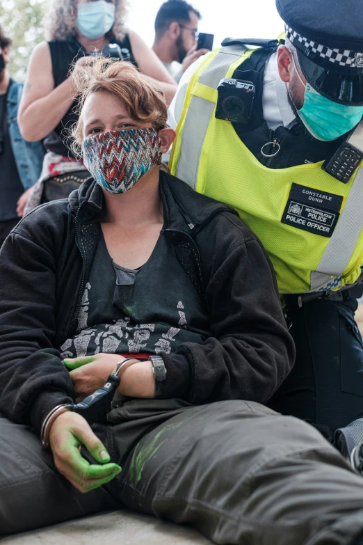 several people wearing masks are gathered around