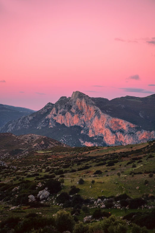 a mountain is in the background at sunset