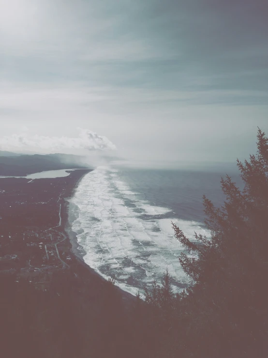 an ocean view with the water crashing in to shore