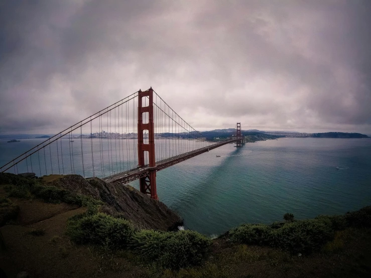 a picture looking across the water at a bridge