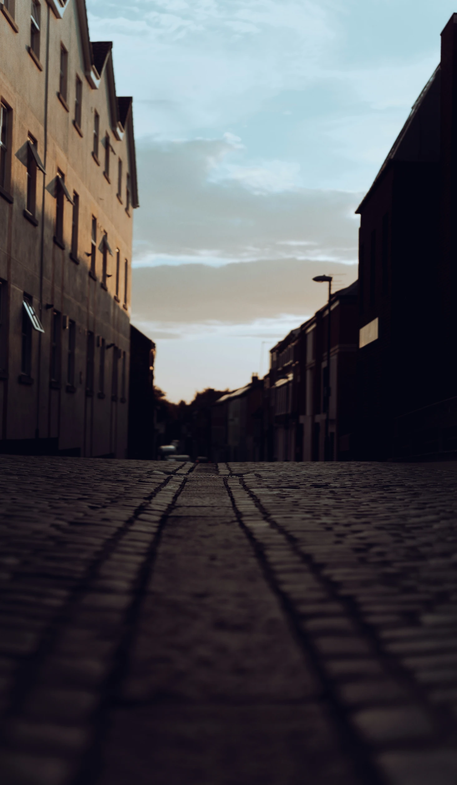 an empty city street at night with light shining on it