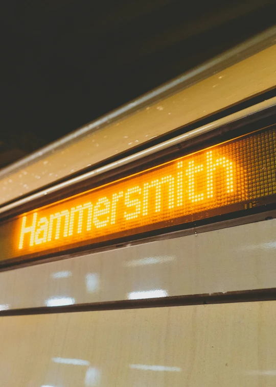 an old school hummshilf sign showing the time