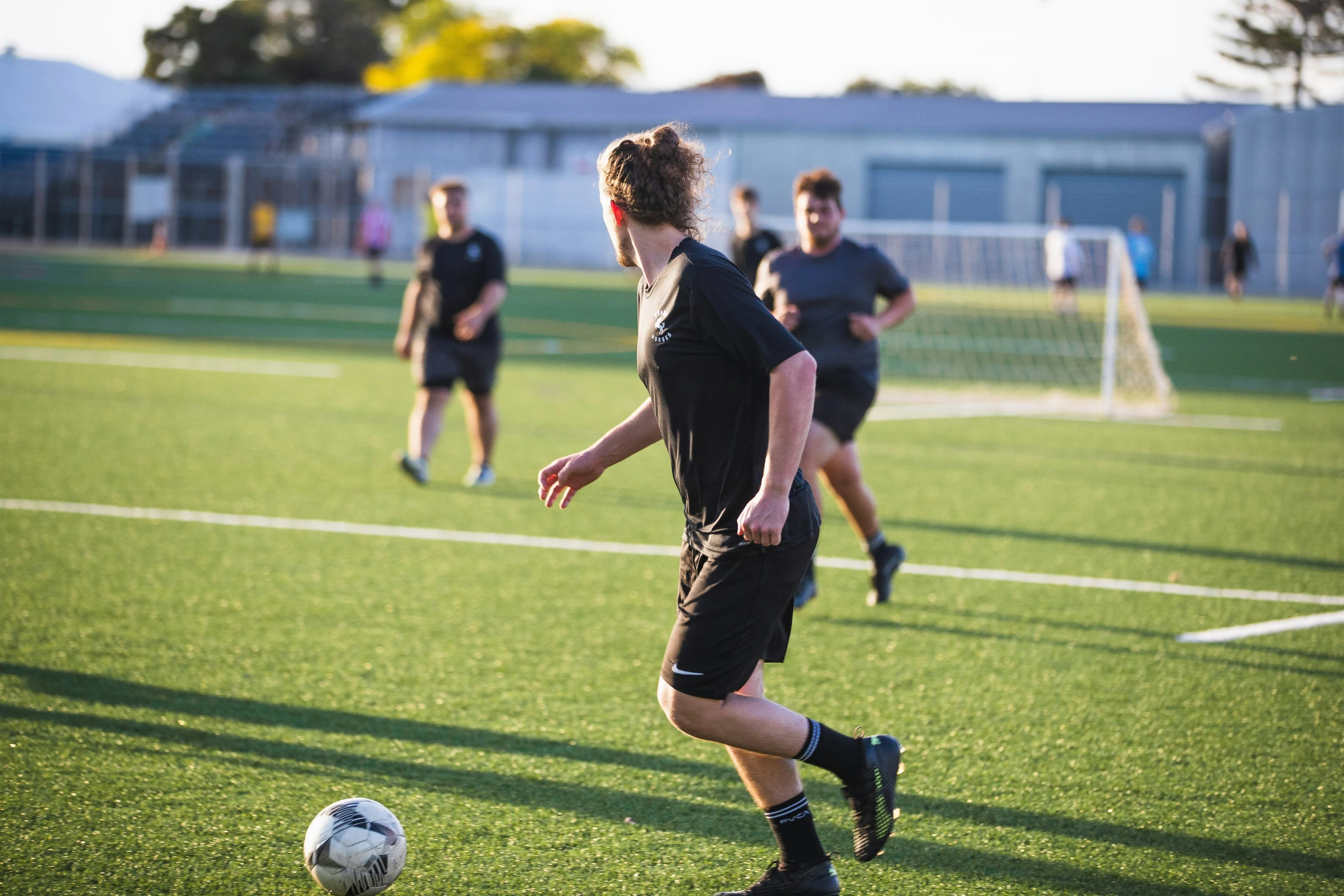 a  kicking a soccer ball on a field