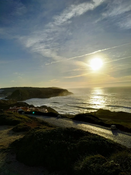 a scenic sunset view over the ocean and cliffs