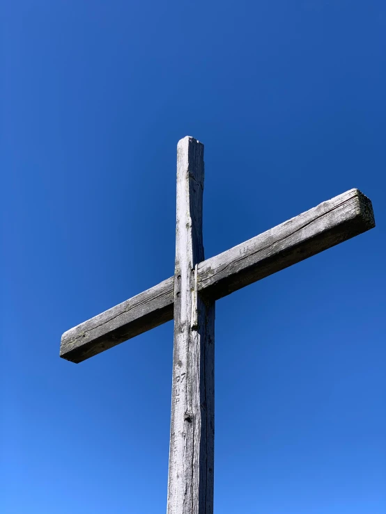 a wooden cross on top of a hill