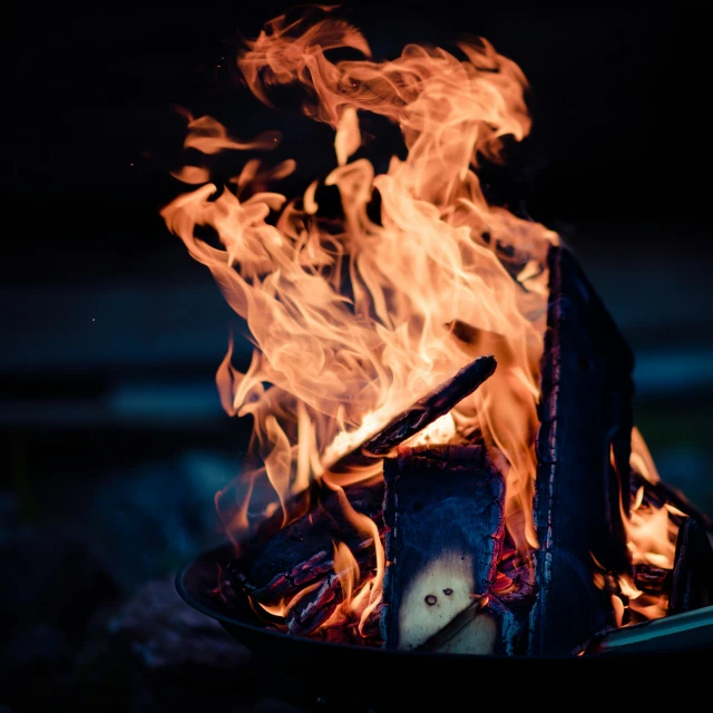 a flame in the center of a metal pot