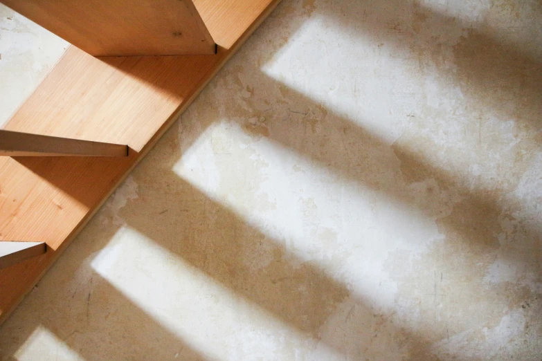 a corner of a room with wooden shelves next to a window