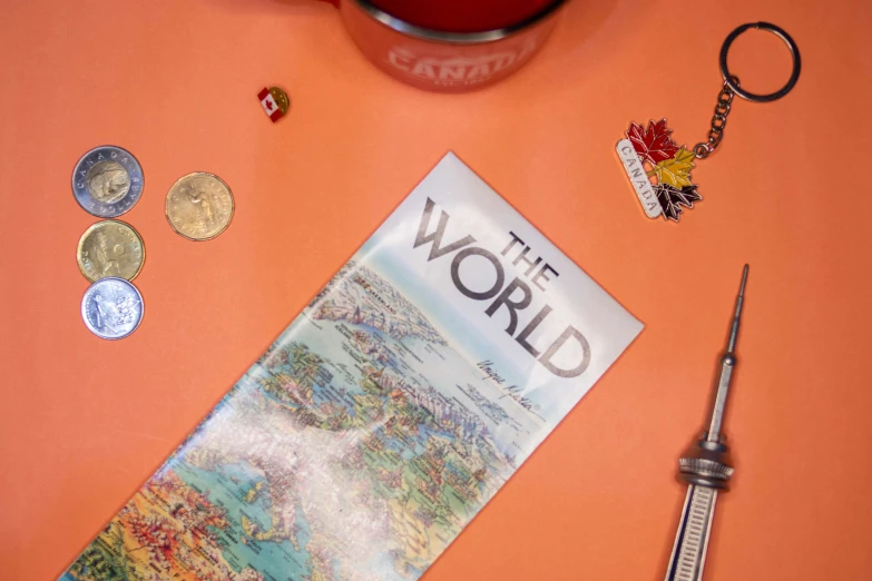 a magazine with some tiny items next to it on a table