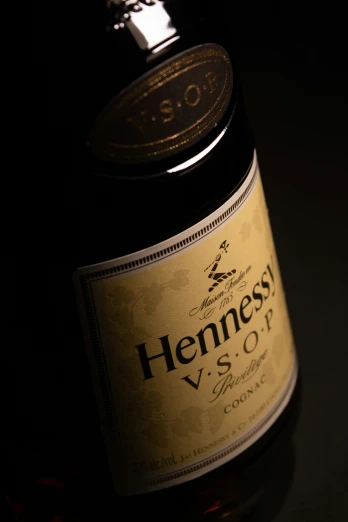 an open bottle of henness v s o p cognage with a cap