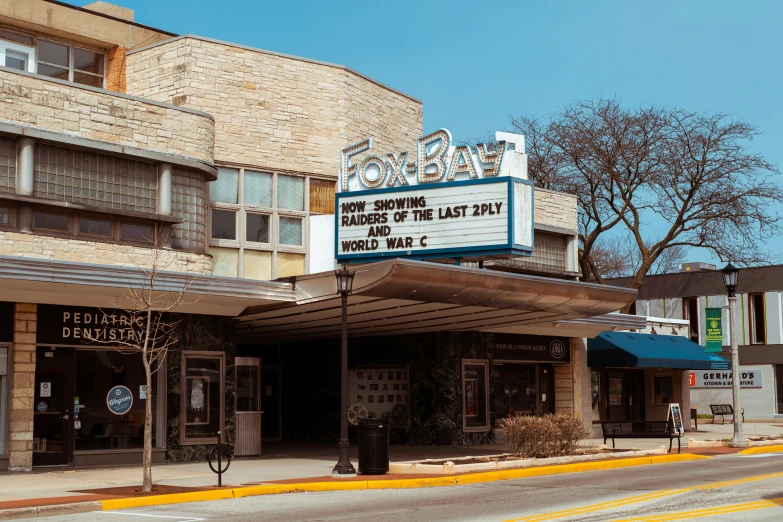 a movie theater sitting on the corner of a city street